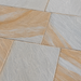 Close-up of Kandla Grey Indian sandstone paving showing natural riven texture with grey and warm golden brown colour variation.
