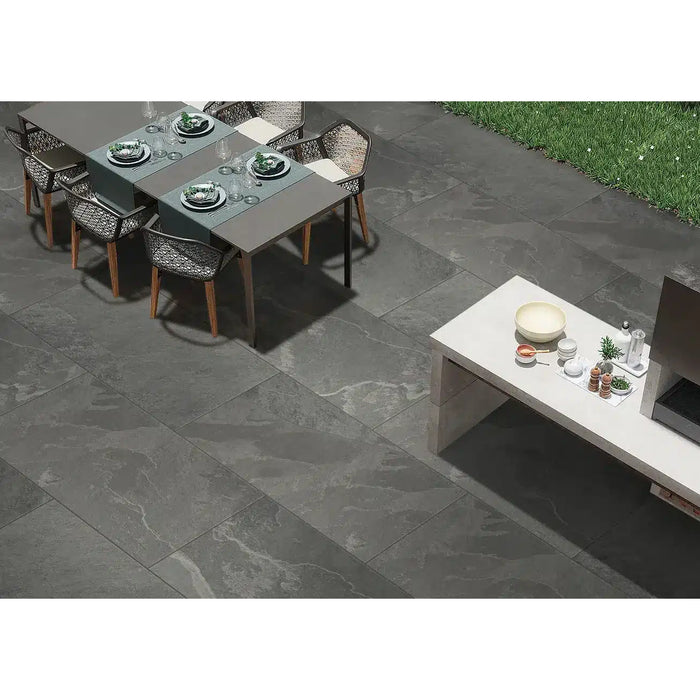 Lake Anthracite porcelain paving installed in a contemporary outdoor dining and kitchen area