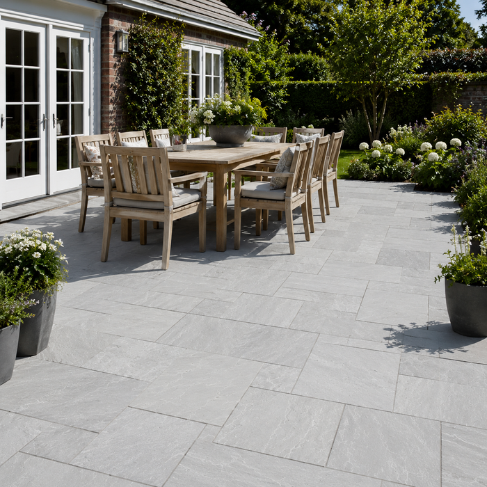 Light Grey Indian sandstone patio with outdoor dining furniture and natural grey paving tones