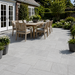 Light Grey Indian sandstone patio with outdoor dining furniture and natural grey paving tones