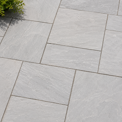 Close up of Light Grey Indian sandstone showing natural riven texture and pale grey veining