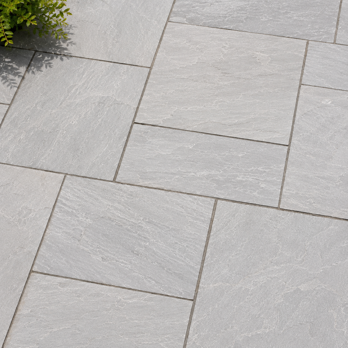 Close up of Light Grey Indian sandstone showing natural riven texture and pale grey veining