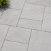 Close up of Light Grey Indian sandstone showing natural riven texture and pale grey veining