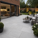 Light Grey sandstone patio installed outside modern bifold doors with garden seating