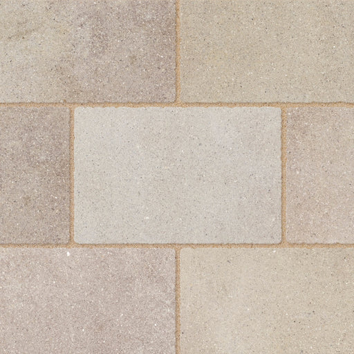 Close-up of Marshalls Carto Sand Multi concrete block paving showing the mixed warm beige and natural stone tones.