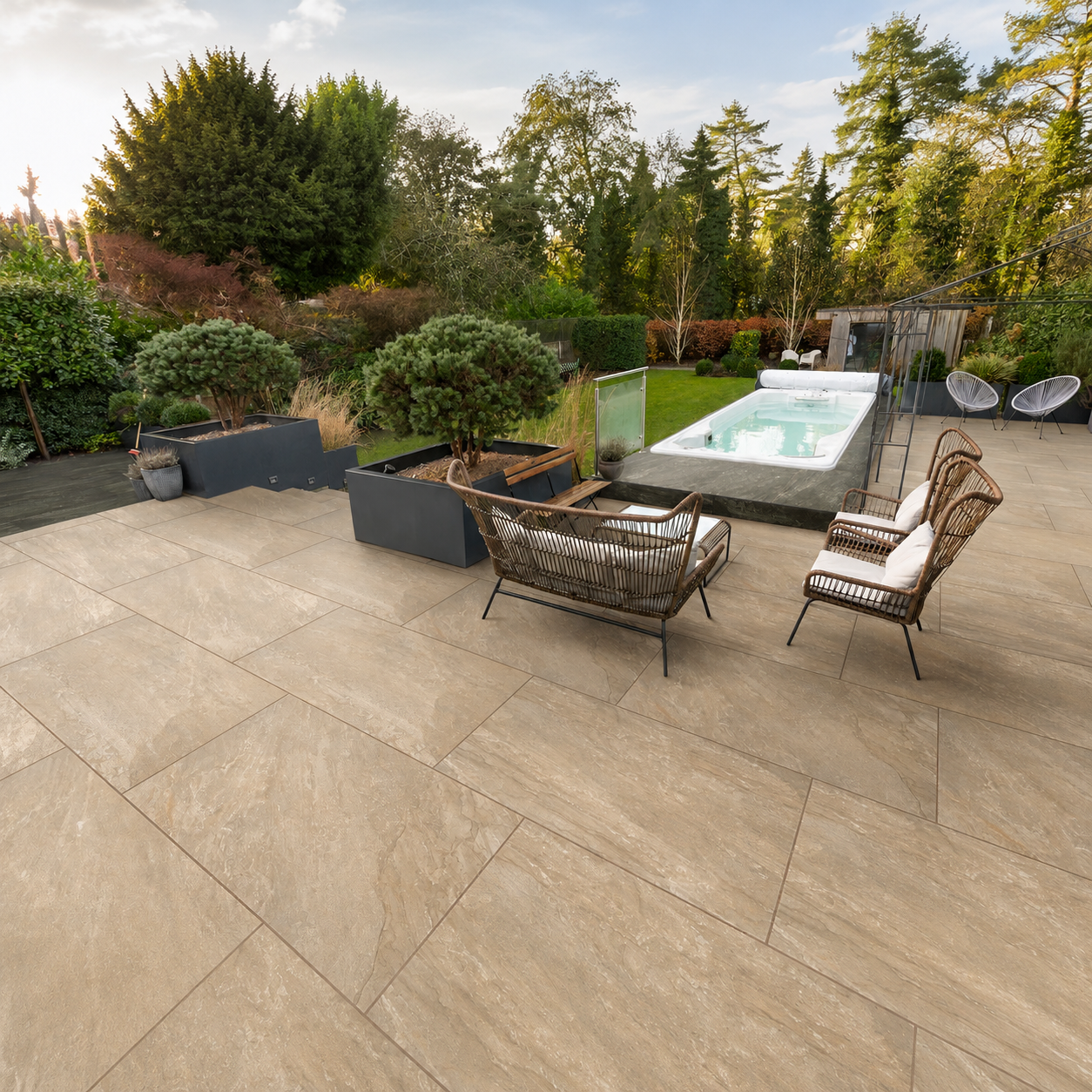 Marshalls Juno Beige porcelain paving installed on a modern garden patio with pool and seating area