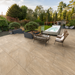 Marshalls Juno Beige porcelain paving installed on a modern garden patio with pool and seating area