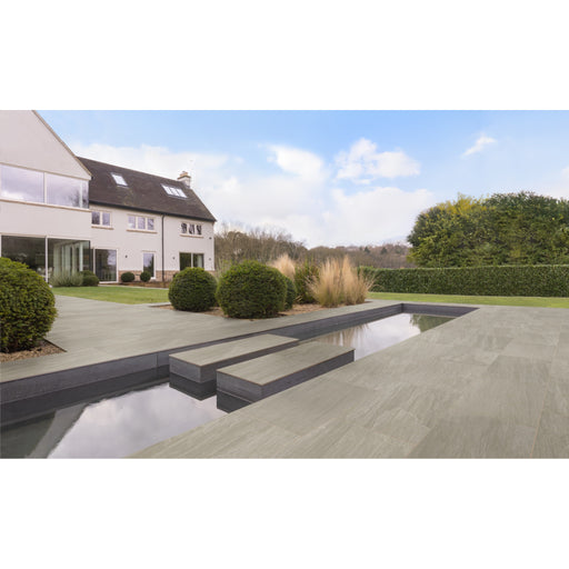 Marshalls Vedastone Grey Multi porcelain paving used around a modern patio and water feature