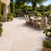 Mint Fossil sandstone garden dining patio with pale beige and buff natural stone paving
