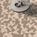 Beige geometric patterned porcelain paving installed beneath a contemporary round table.