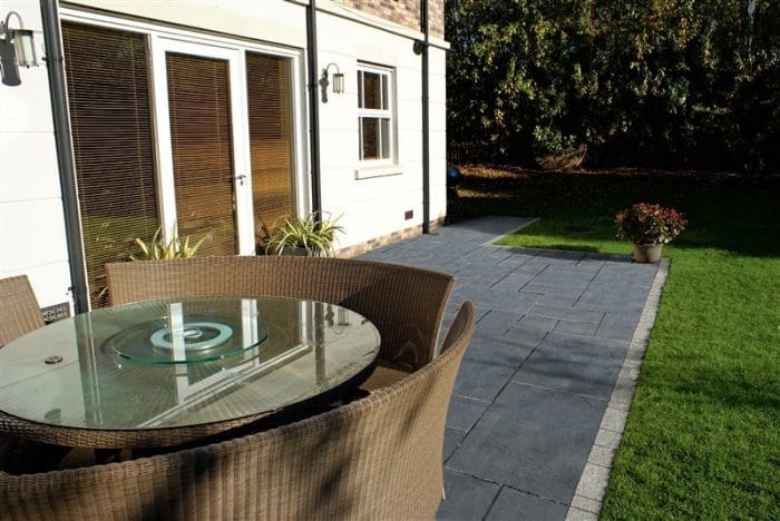 Paveworld Black Lime dark limestone paving installed patio