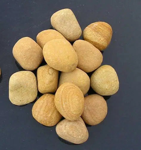 Paveworld Golden Sandstone Pebbles showing smooth tumbled golden stone finish