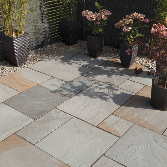Paveworld Kandla Blend sandstone paving installed patio showing grey buff and rusty tones
