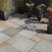 Paveworld Kandla Blend sandstone paving installed patio showing grey buff and rusty tones