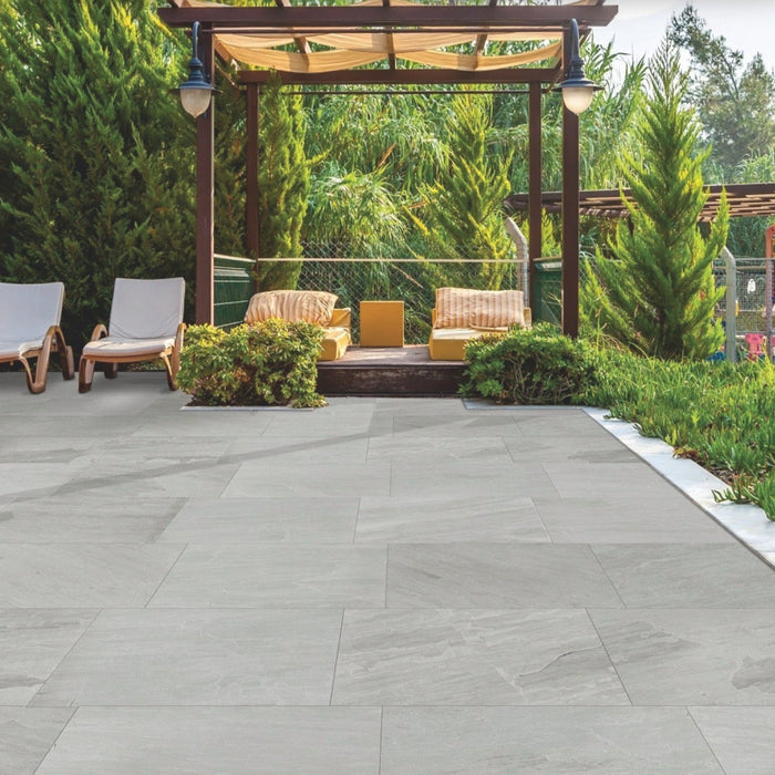 Paveworld Lake Kandla Grey porcelain paving 900x600 slabs installed on a contemporary garden patio with pergola and seating area