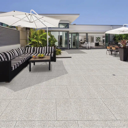 Paveworld Lake Silver Granite manufacturer image showing installed porcelain paving patio