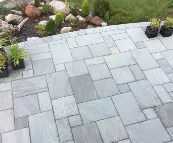Paveworld Light Grey Sandstone 22mm calibrated paving laid in a mixed-size patio pattern