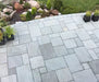Paveworld Light Grey Sandstone 22mm calibrated paving laid in a mixed-size patio pattern