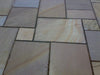 Paveworld Rippon Buff sandstone slabs showing riven surface and earthy tones