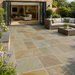 Raj Green sandstone paving installed with outdoor seating and garden planting