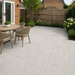 Silver Granite porcelain paving laid in a traditional English rear garden with dining table, timber fencing and planted borders.
